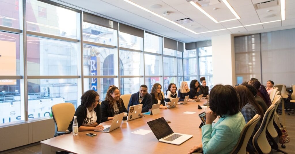 A diverse team of business professionals collaborating in a modern meeting room.