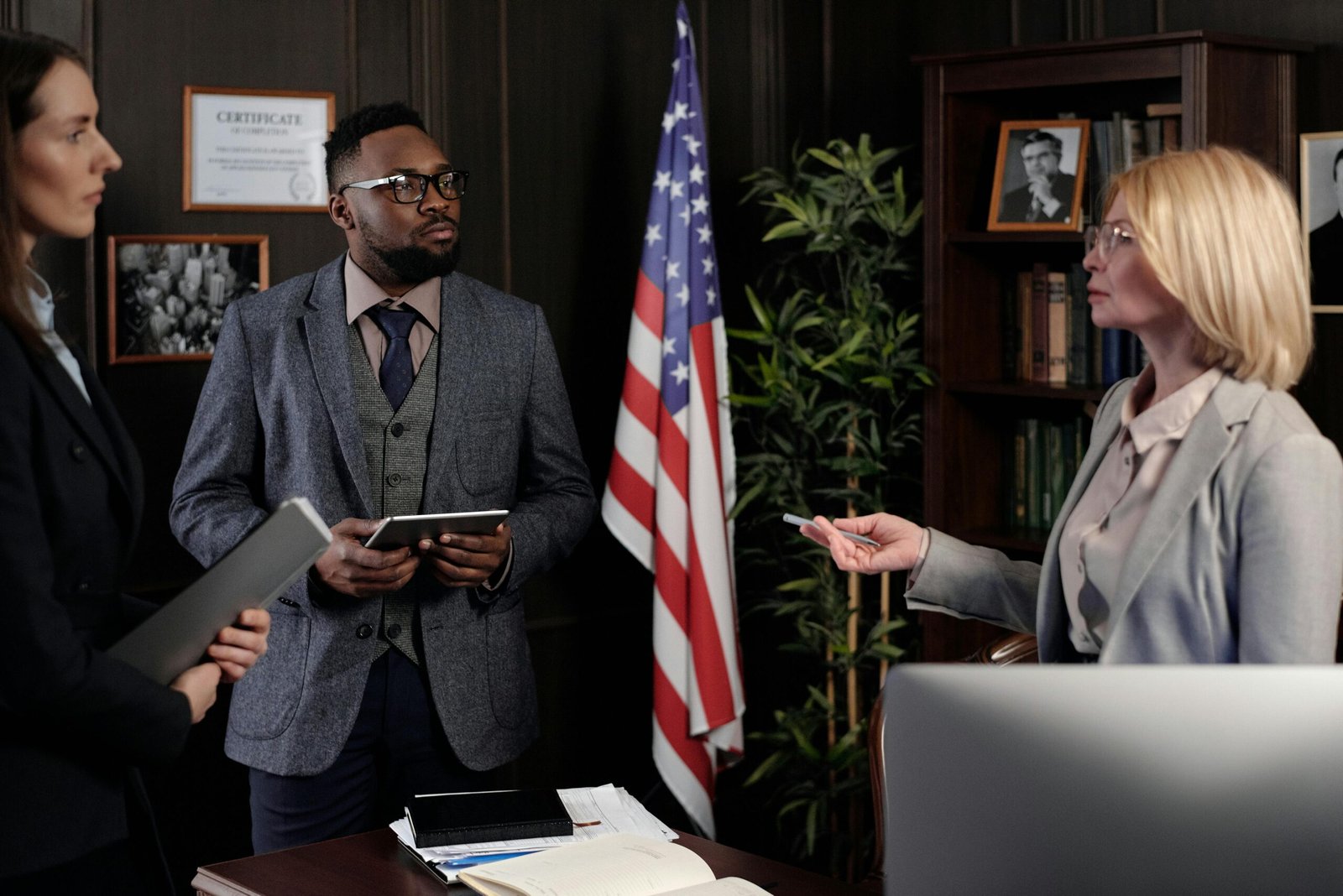 Diverse group of lawyers in a serious office meeting discussing legal matters.